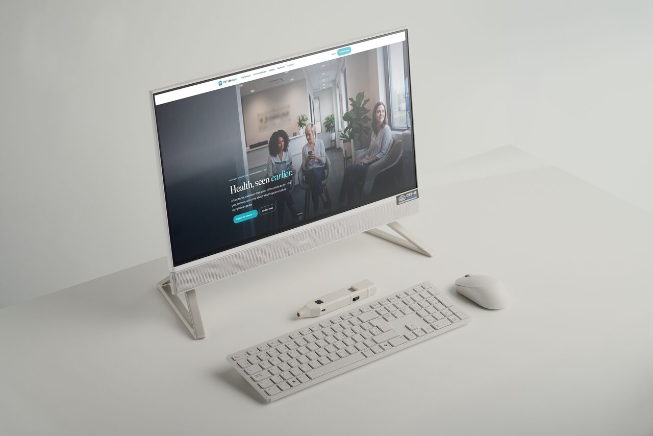 The CRT LifeScan probe beside an all-in-one desktop workstation, keyboard and mouse