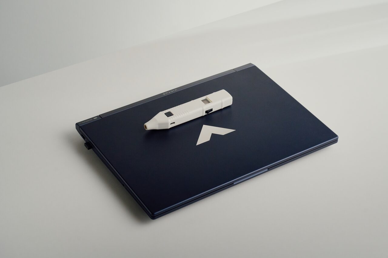The CRT LifeScan probe resting on a closed laptop, ready to travel