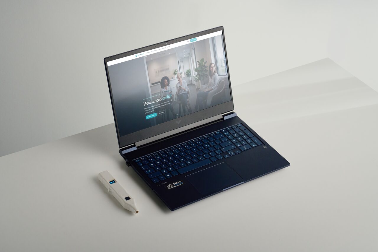The CRT LifeScan probe next to an open laptop running CRT LifeScan